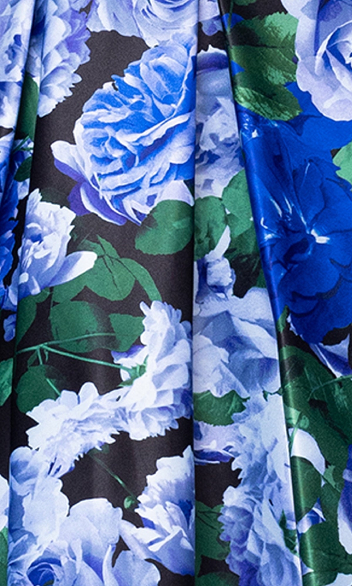 Close-up of the fabric on the Strapless Print Hoco Dress: Blondie Nites 5592BN, featuring an affordable semi-formal style with a blue and white floral pattern, green leaves, and detailed petals on a dark background.